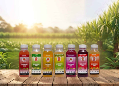 Row of sugarcane juice bottles on a wooden table with a natural background